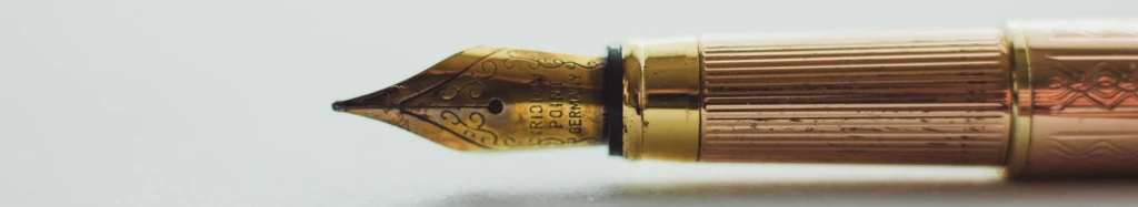 Fountain pen nib close-up, symbolizing precision in market research brief preparation and communication.
