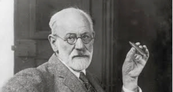 Sigmund Freud, influential psychologist, holding a pen, illustrating the foundation of psychoanalytic theory related to brand archetypes.