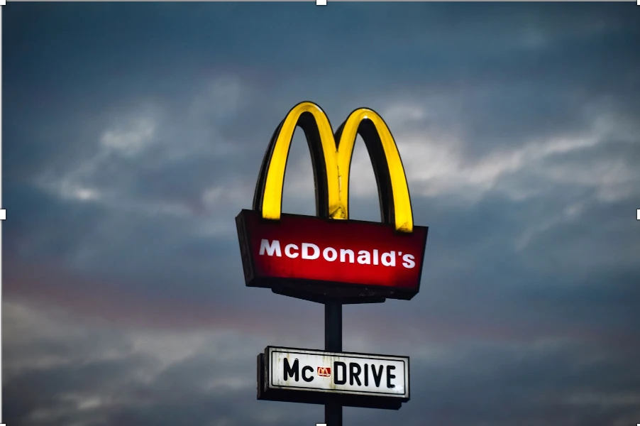 McDonald's restaurant sign with iconic golden arches and "Mc DRIVE" text, illustrating brand recognition and color semiotics in marketing.