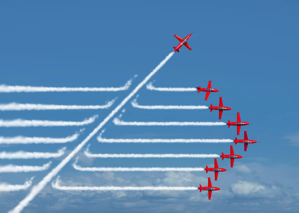 Red aerobatic planes performing a formation flight, illustrating dynamic movement and precision in advertising effectiveness.