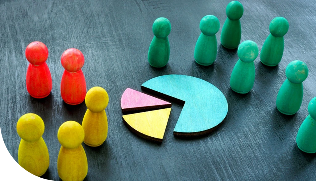 Colorful wooden figures representing market segments and a pie chart illustrating market segmentation research.
